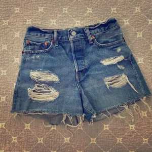 Levi’s Mid-High Waisted Distressed Shorts, W27